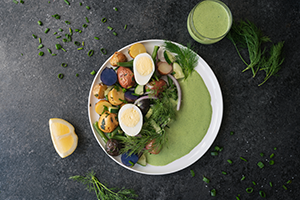 Green Goddess Potato Salad. Colored potatos with a green goddess dressing. This salad is topped with a hard boiled egg, dill, onions, and salt.