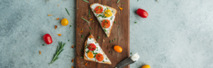Tomato Toasts with Herbed Farmer's Cheese on a wooden board