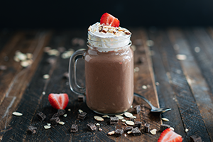 Chocolate Kefir Milkshake Topped with Coconut Cream and Strawberries