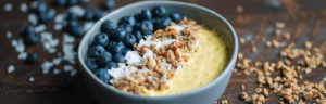 Golden Mylk Skyr Bowl Topped with Blueberries, Coconut Flakes, and Granola