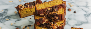Golden Turmeric Kefir Banana Bread Stacked with chocolate chips and almond slices