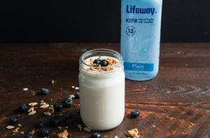 Kefir topped with granola and blueberries