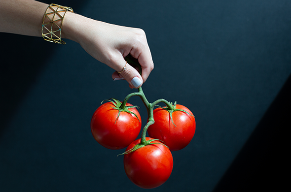Tomato being held by hand
