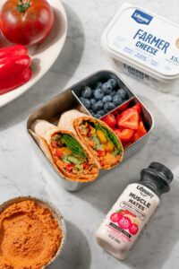 Easy Protein Veggie Wraps made with Lifeway Farmer Cheese packed in a lunchbox with Lifeway Muscle Mates