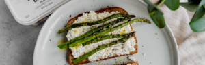 Roasted Asparagus Lemon Zest Toast made with asparagus, lemon zest, black pepper.olive oil, and probiotic, protein-rich Lifeway Farmer Cheese.